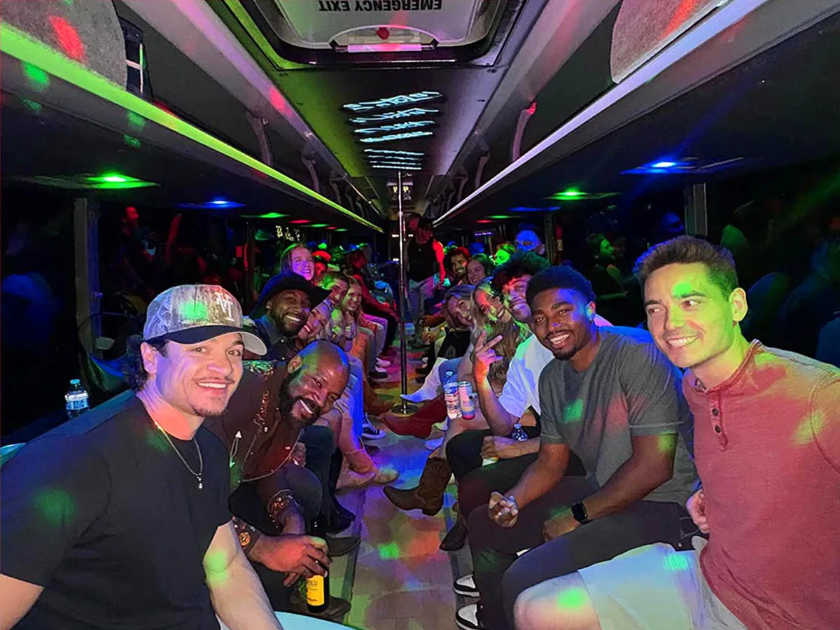 Group enjoying the party bus during the Buffalo Chip Cave Creek Transportation for a night of country music, dancing, and nightlife